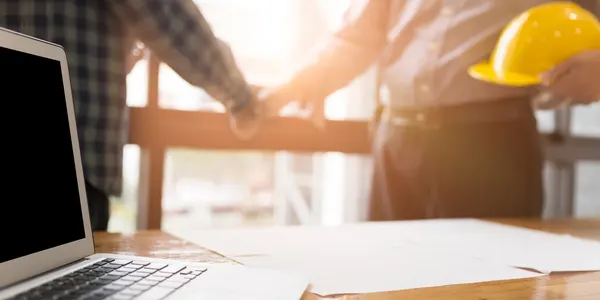 Two people holding hands over a table